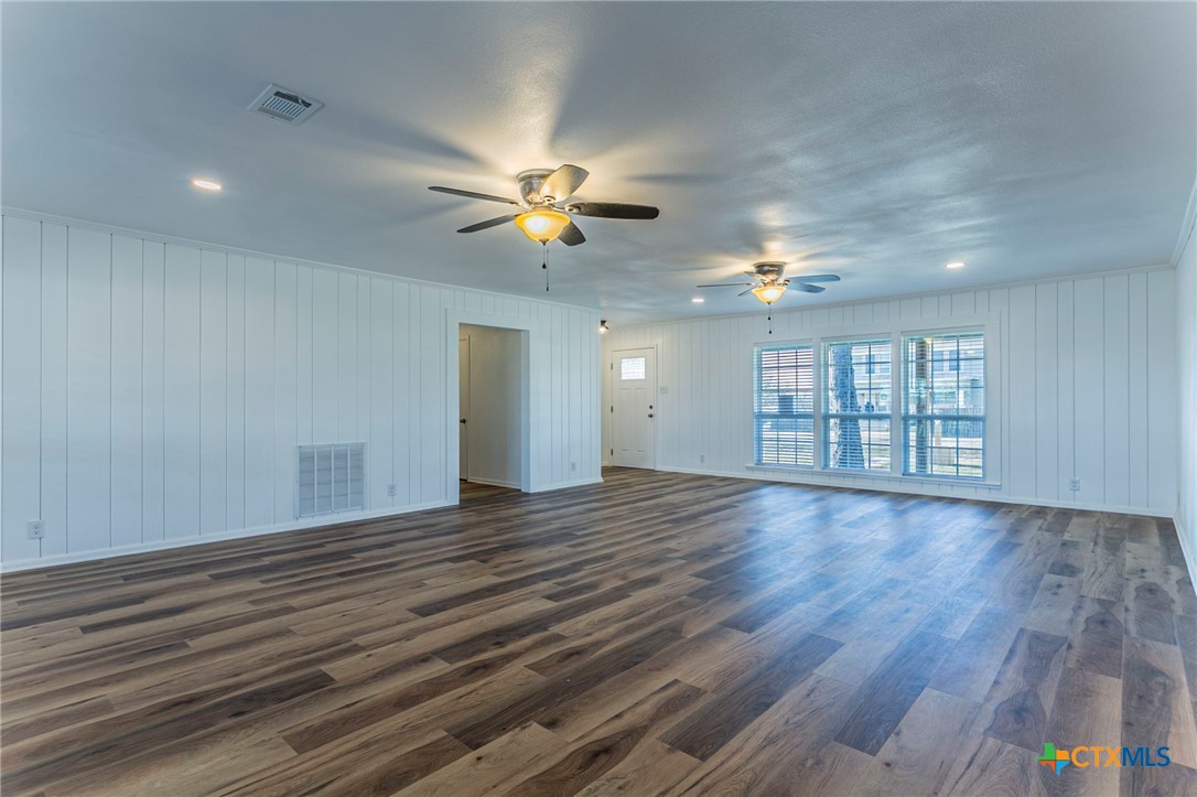 301 Thomas Street Rogers, TX 76569 - Photo 4 of 29 a view of an empty room with a window and wooden floor