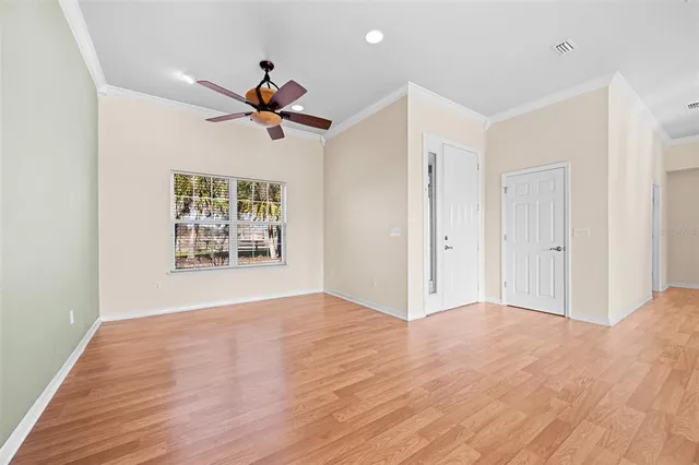 a view of a livingroom with a ceiling fan & window