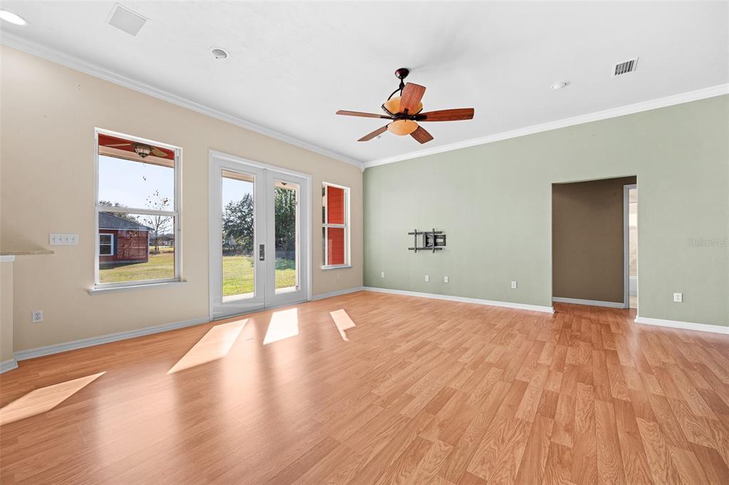 10215 Southwest 98th Avenue Gainesville, FL 32608 - Photo 11 of 43 a view of an empty room with a window and wooden floor