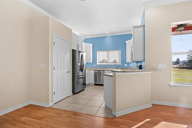 a kitchen with stainless steel appliances a refrigerator sink and cabinets