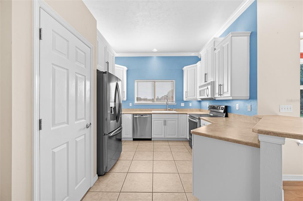 10215 Southwest 98th Avenue Gainesville, FL 32608 - Photo 16 of 43 a kitchen with a sink stove and refrigerator