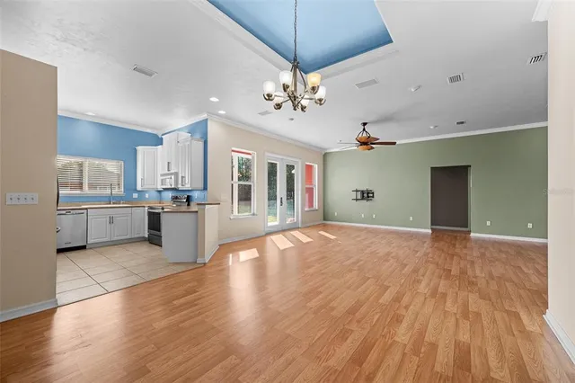 a view of a kitchen with wooden floor and windows