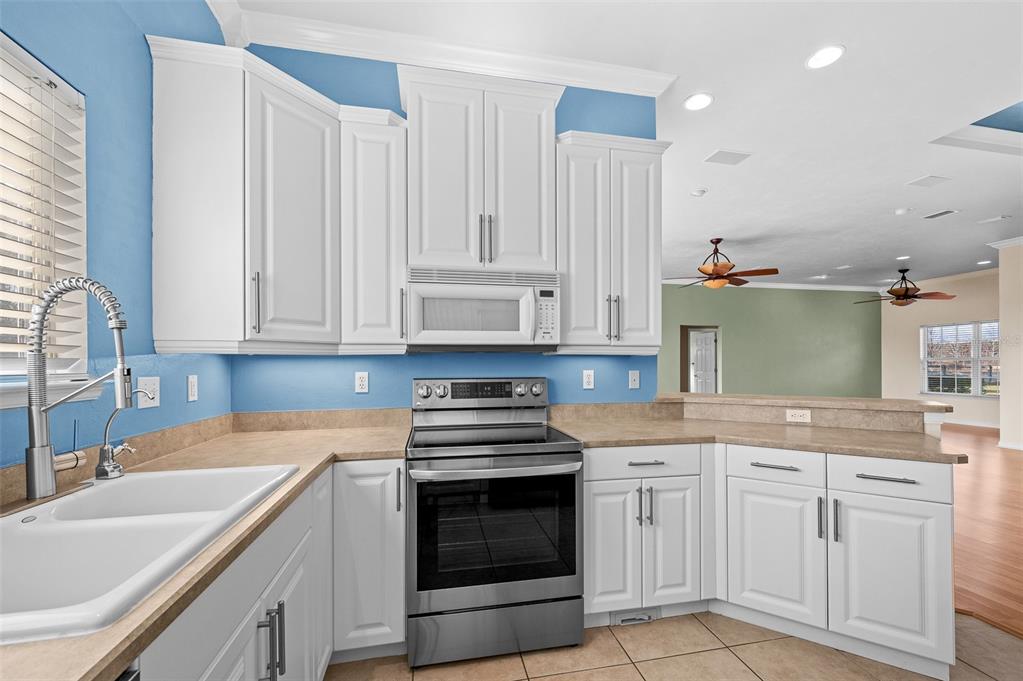 10215 Southwest 98th Avenue Gainesville, FL 32608 - Photo 18 of 43 a kitchen with granite countertop a sink and cabinets
