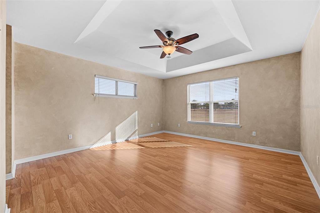 10215 Southwest 98th Avenue Gainesville, FL 32608 - Photo 21 of 43 a view of empty room with wooden floor and fan