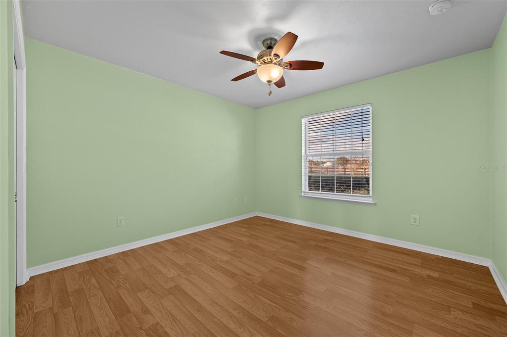 10215 Southwest 98th Avenue Gainesville, FL 32608 - Photo 25 of 39 a view of a big room with wooden floor and windows