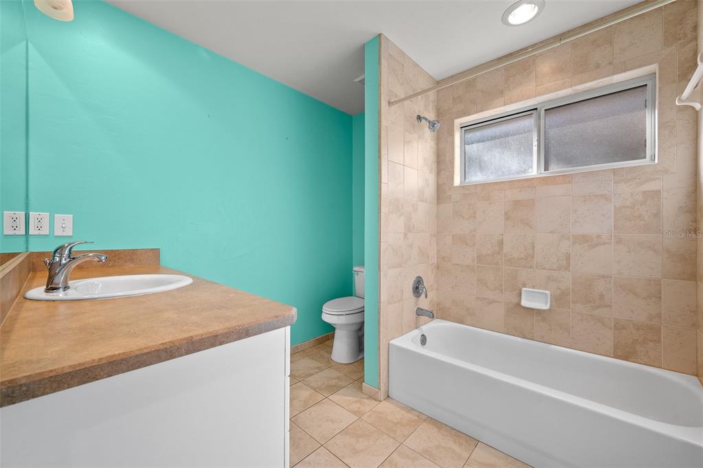 10215 Southwest 98th Avenue Gainesville, FL 32608 - Photo 26 of 39 a bathroom with a granite countertop bathtub shower sink vanity and toilet