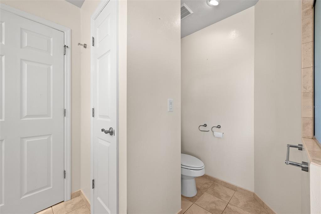 10215 Southwest 98th Avenue Gainesville, FL 32608 - Photo 27 of 43 a bathroom with a granite countertop toilet a sink and shower