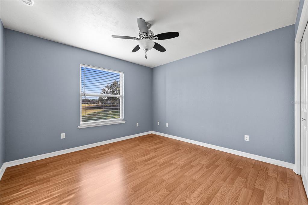 10215 Southwest 98th Avenue Gainesville, FL 32608 - Photo 27 of 39 an empty room with wooden floor and windows