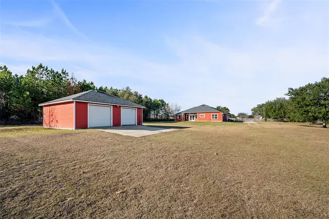 a big house with a big yard and large trees