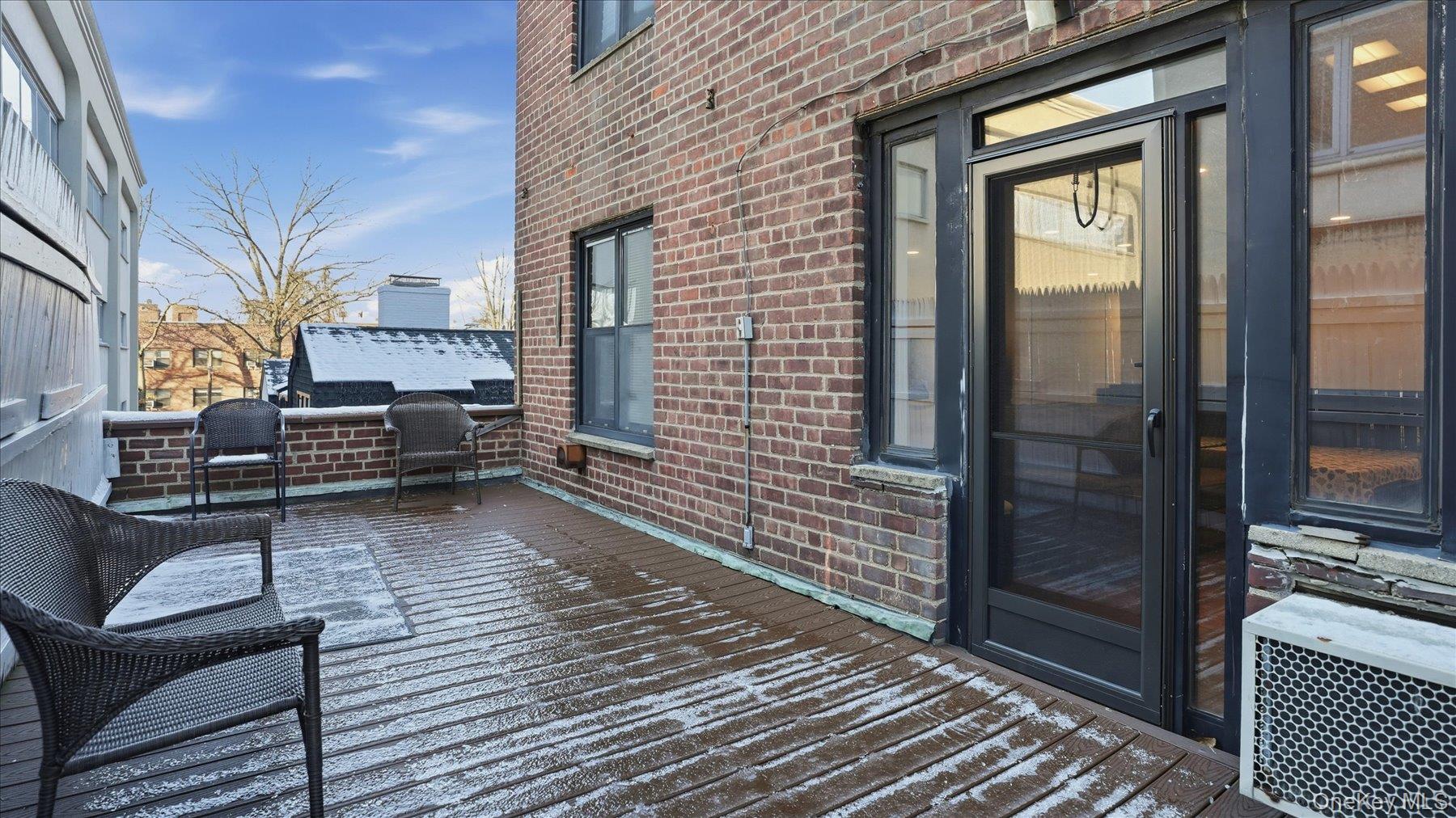 46 Grace Avenue, Unit 1L Great Neck, NY 11021 - Photo 2 of 16 a view of a balcony with chairs and wooden floor