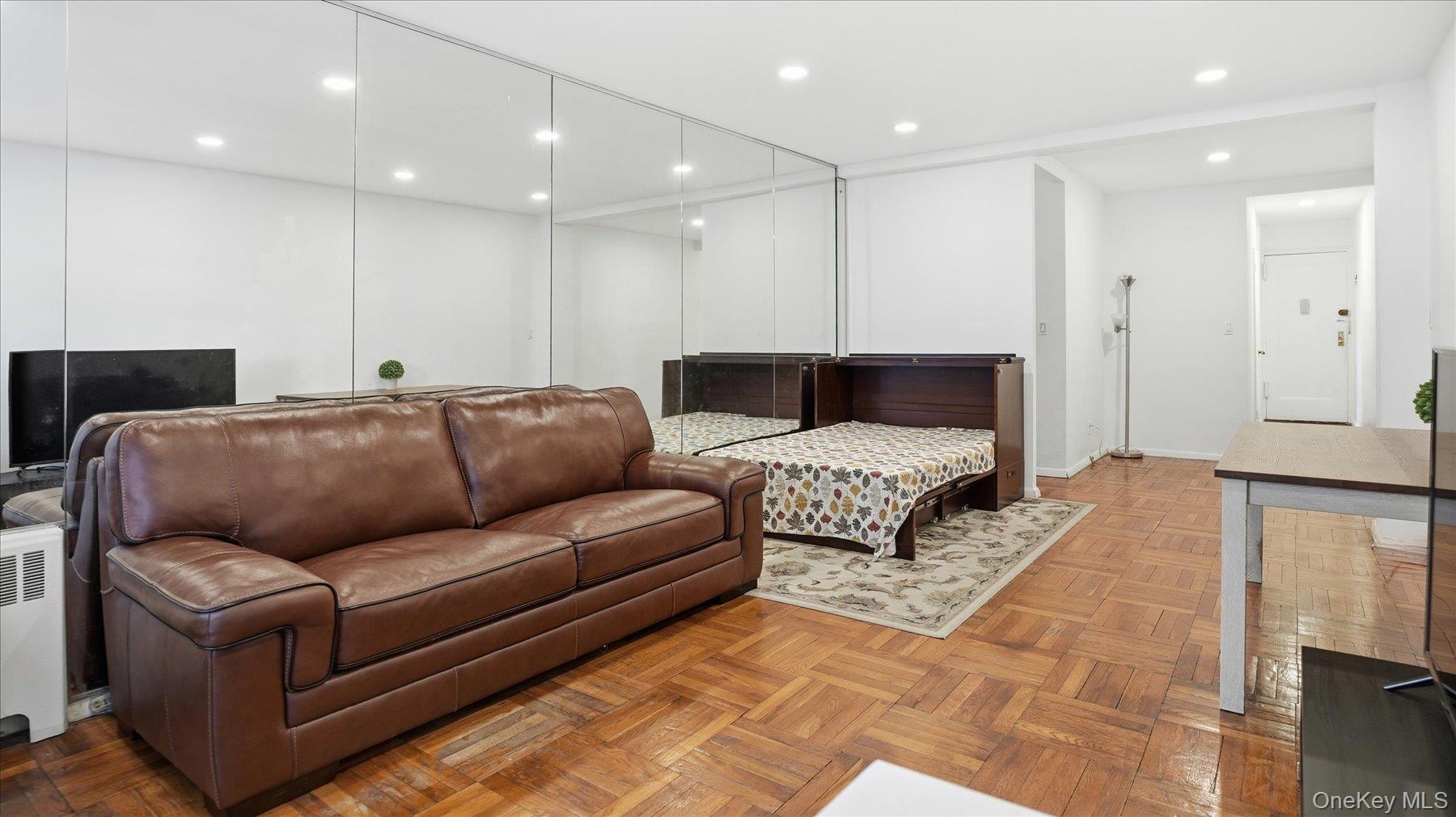 46 Grace Avenue, Unit 1L Great Neck, NY 11021 - Photo 4 of 16 a living room with furniture and a couch