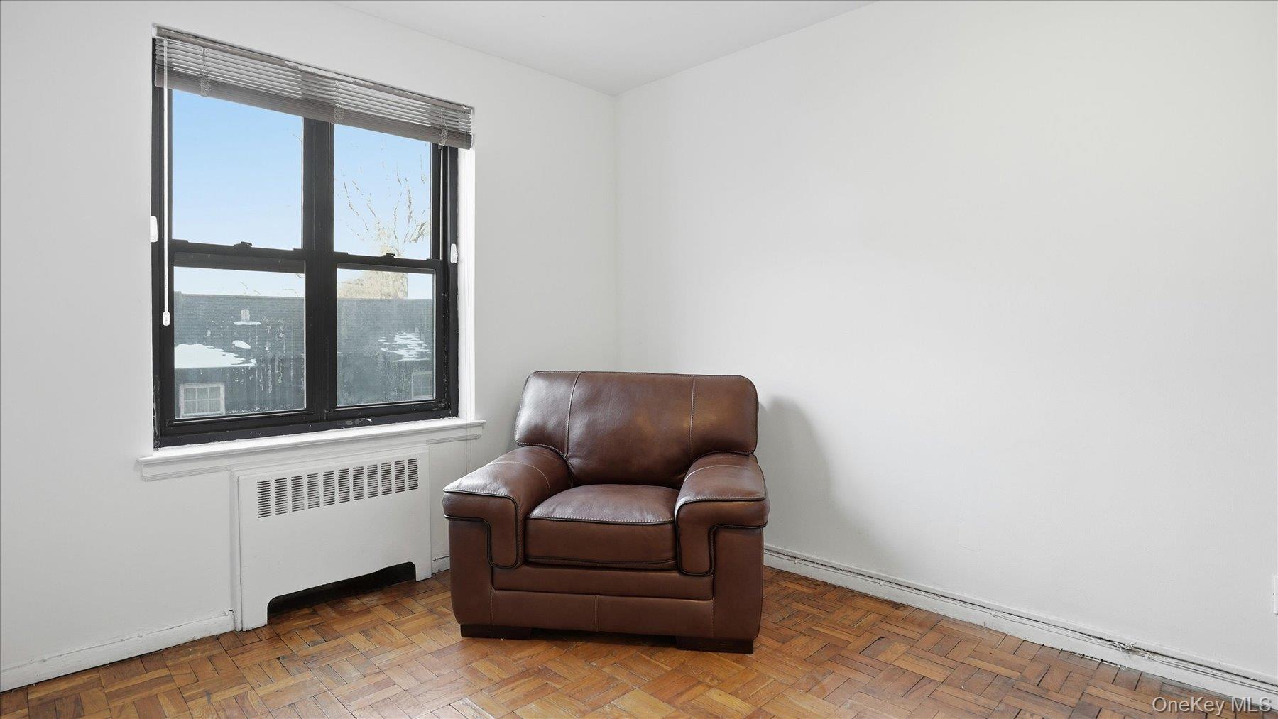 46 Grace Avenue, Unit 1L Great Neck, NY 11021 - Photo 8 of 16 a living room with furniture and a window
