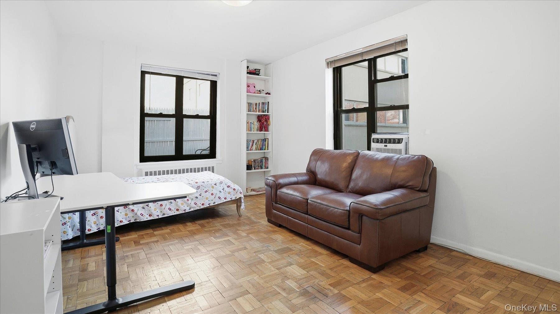 46 Grace Avenue, Unit 1L Great Neck, NY 11021 - Photo 10 of 16 a living room with furniture fireplace and window