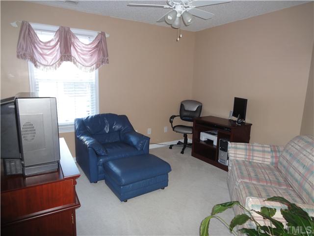 4621 Drewbridge Way Raleigh, NC 27604 - Photo 16 of 25 Second bedroom is currently being used as a sitting room with ceiling fan.