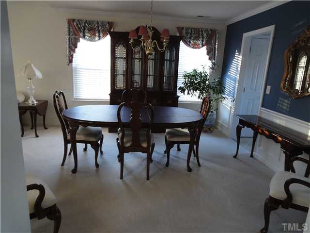 4621 Drewbridge Way Raleigh, NC 27604 - Photo 5 of 25 Dining room has crown molding, chair railing, & wainscoting.