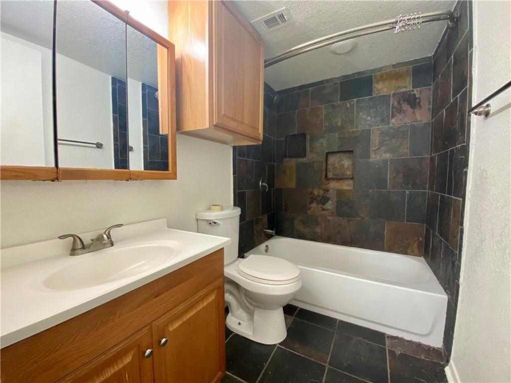 3000 Guadalupe Street, Unit 116 Austin, TX 78705 - Photo 5 of 6 a bathroom with a sink a toilet and shower