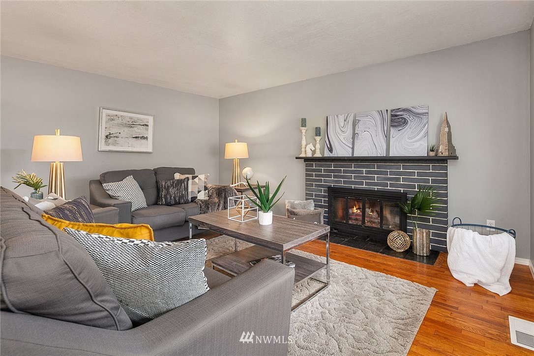 12432 169th Avenue Southeast Renton, WA 98059 - Photo 3 of 15 a living room with furniture and a fireplace