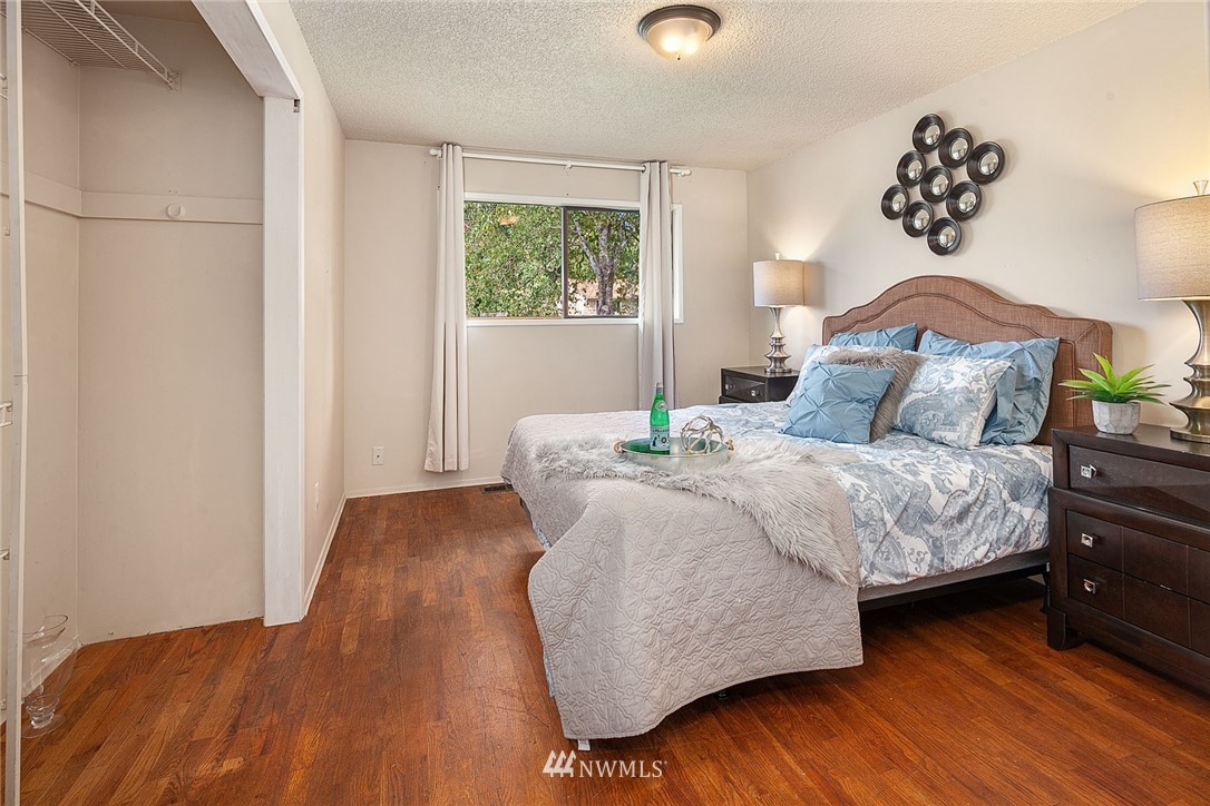 12432 169th Avenue Southeast Renton, WA 98059 - Photo 8 of 15 a bedroom with a bed and wooden floor