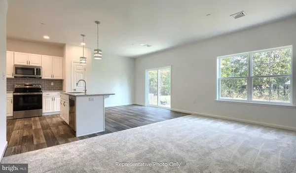 a view of kitchen with sink microwave and refrigerator