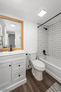 a bathroom with a sink toilet a mirror and shower