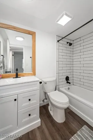 a bathroom with a sink toilet a mirror and shower