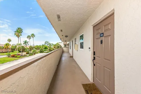 a utility room with washing machine and a view of bedroom