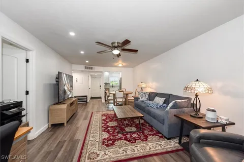 a living room with furniture and a chandelier