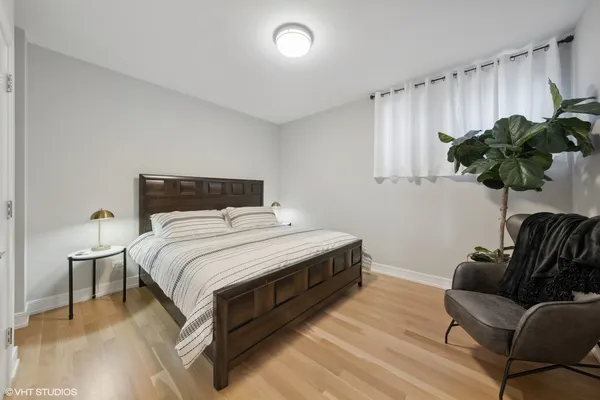 a bedroom with a bed window and couch