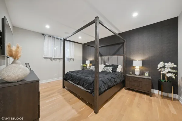 a spacious bedroom with a bed and a flat screen tv