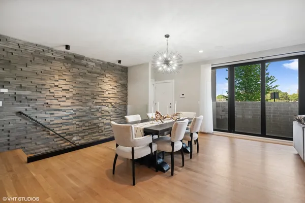 a view of a dining room with furniture wooden floor and chandelier