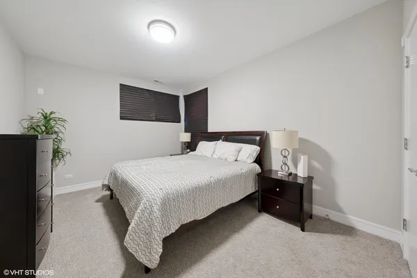 a bedroom with a bed and a potted plant