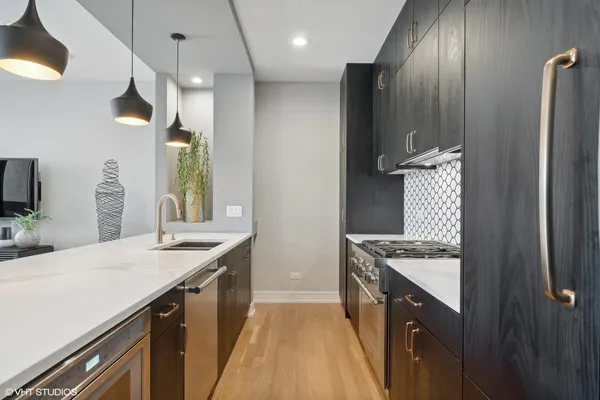 a kitchen with granite countertop a sink stove and cabinets