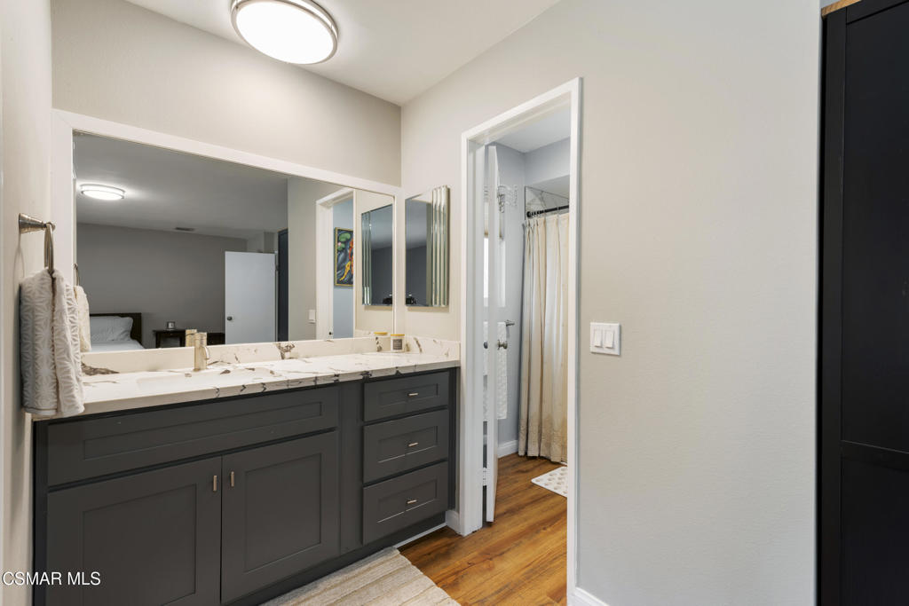 2125 Yosemite Avenue Simi Valley, CA 93063 - Photo 12 of 31 a en suite bathroom with a double vanity sink and mirror