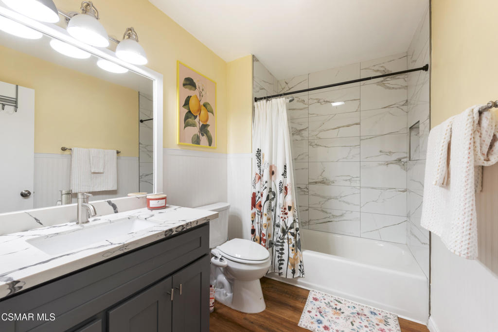 2125 Yosemite Avenue Simi Valley, CA 93063 - Photo 15 of 31 a bathroom with a granite countertop sink toilet a shower and a mirror