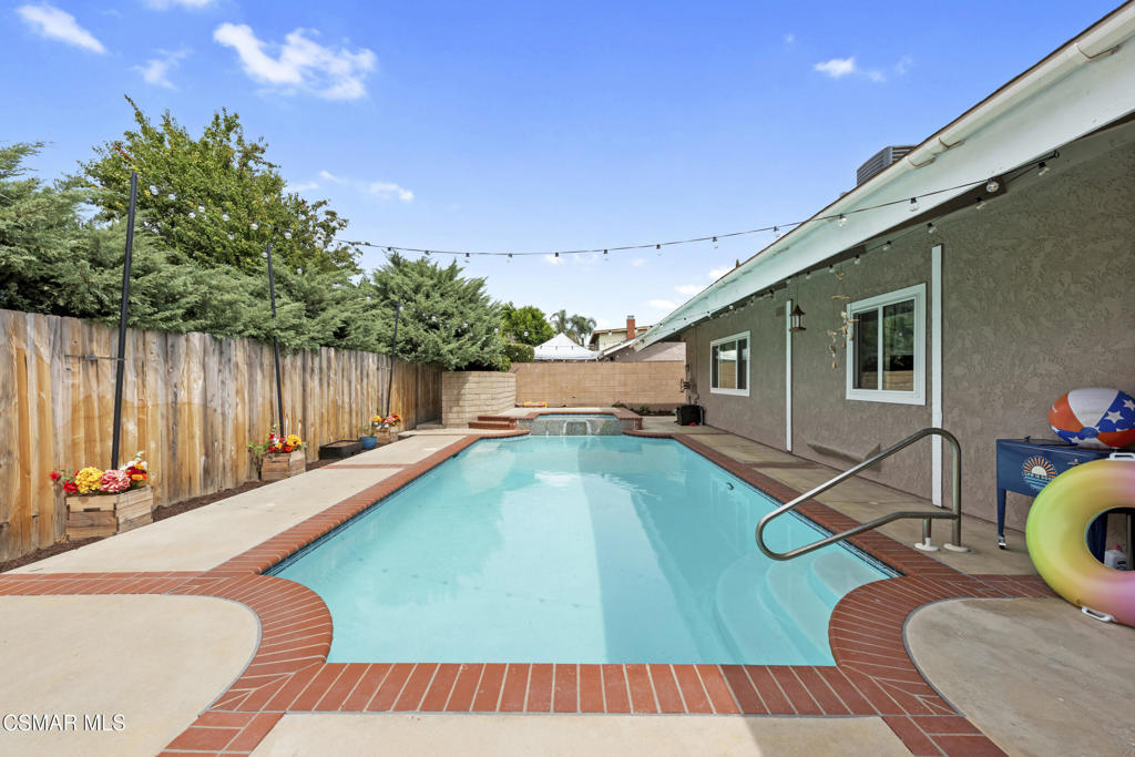 2125 Yosemite Avenue Simi Valley, CA 93063 - Photo 25 of 31 a swimming pool with some potted plants and wooden fence