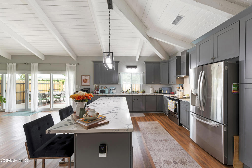 2125 Yosemite Avenue Simi Valley, CA 93063 - Photo 5 of 31 a living room with stainless steel appliances kitchen island granite countertop furniture a refrigerator a sink dishwasher and a stove
