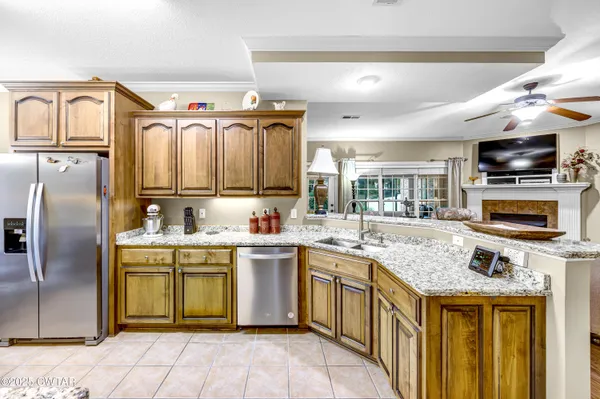 a kitchen with a sink appliances and cabinets