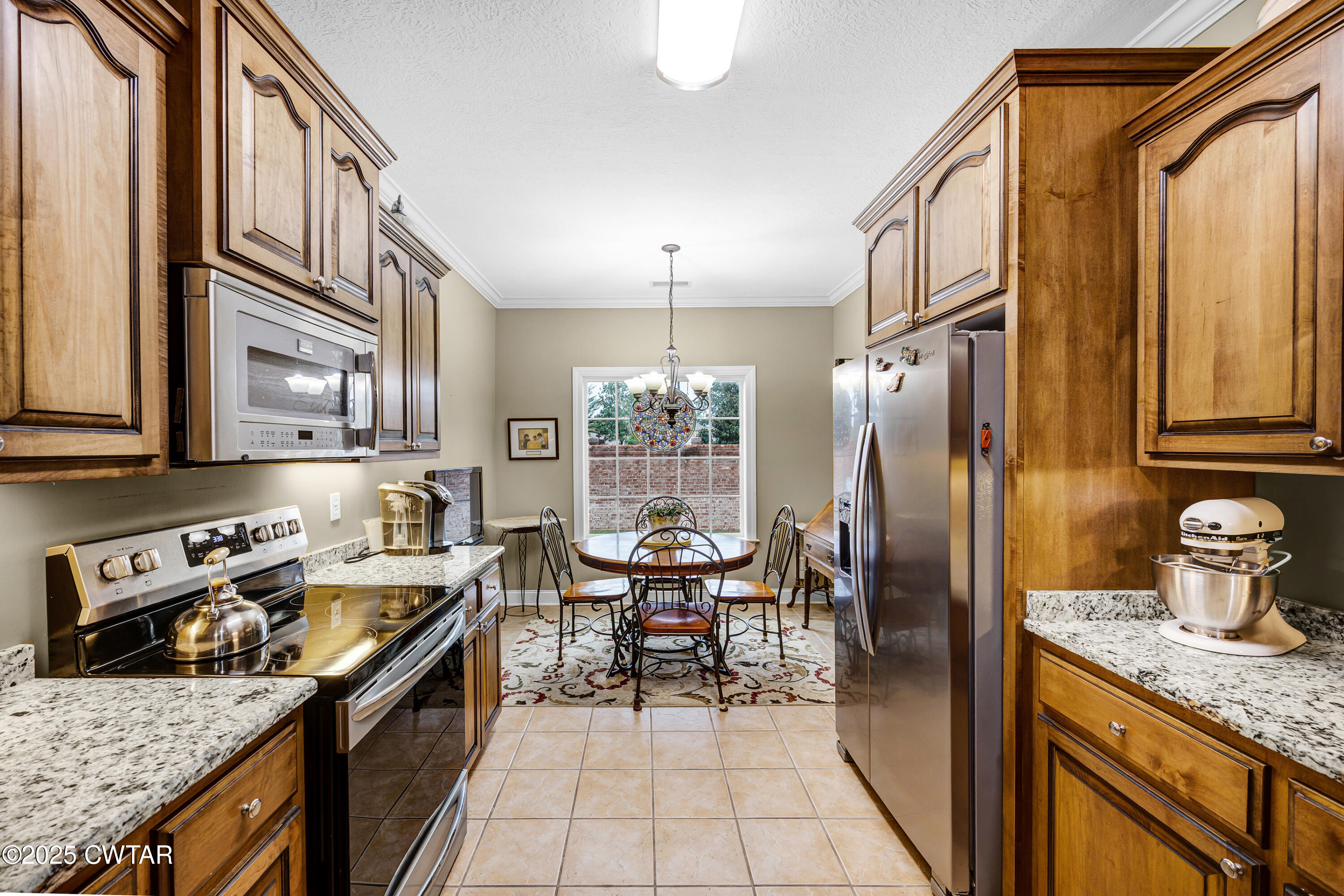 3 Emerald Ridge Cove Jackson, TN 38305 - Photo 13 of 26 a kitchen with stainless steel appliances granite countertop a sink stove and refrigerator