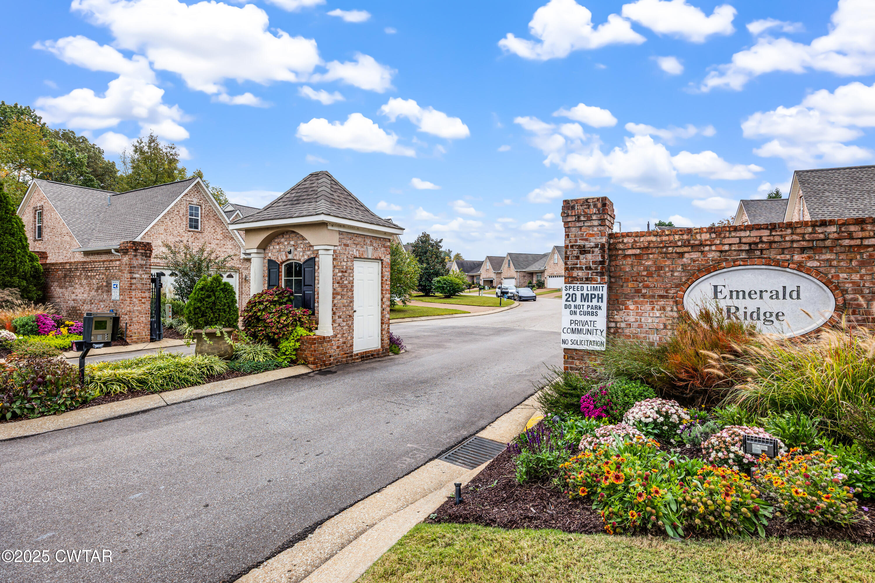 3 Emerald Ridge Cove Jackson, TN 38305 - Photo 2 of 26 a front view of a house with a yard and fountain in middle