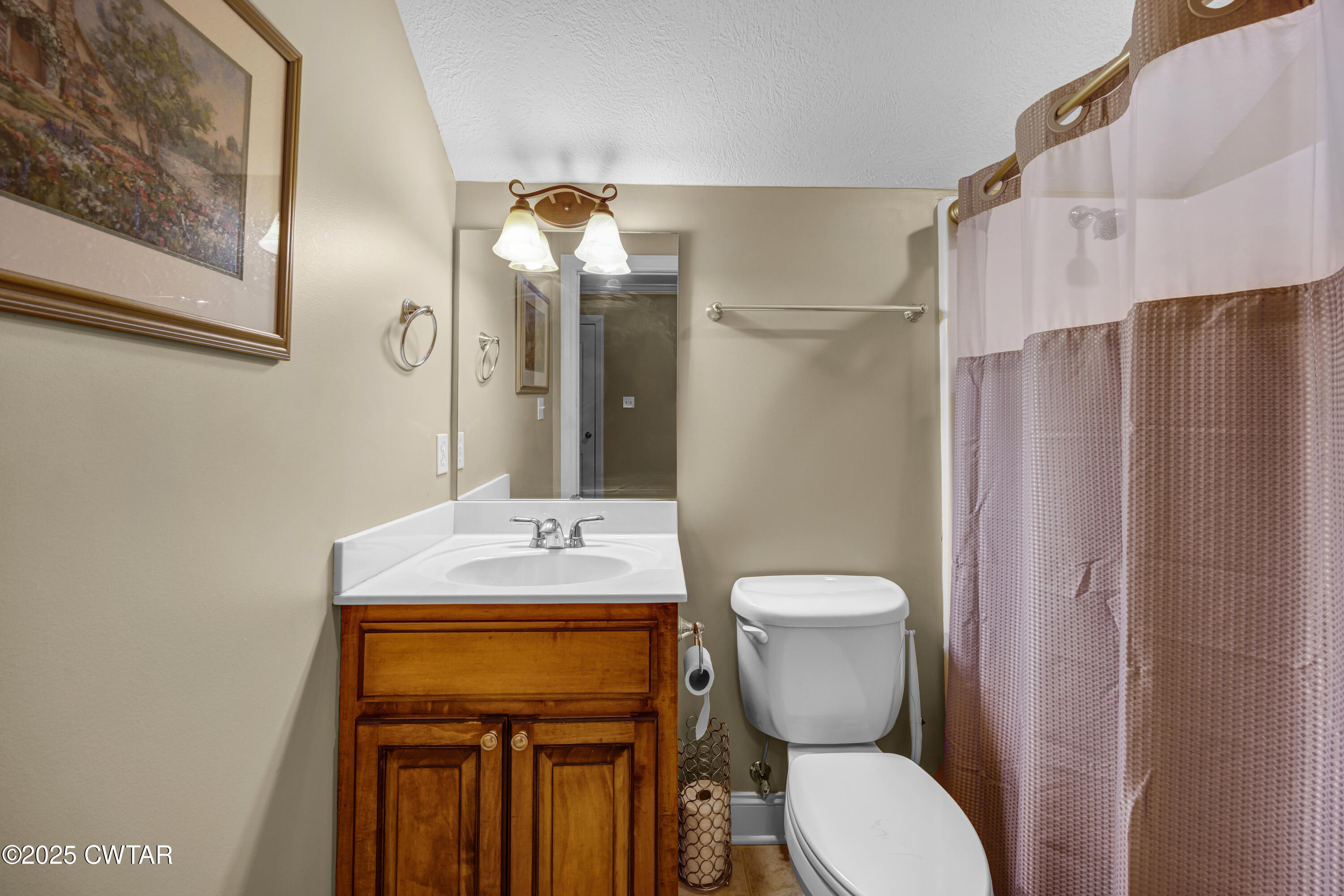 3 Emerald Ridge Cove Jackson, TN 38305 - Photo 25 of 26 a bathroom with a toilet sink shower and mirror