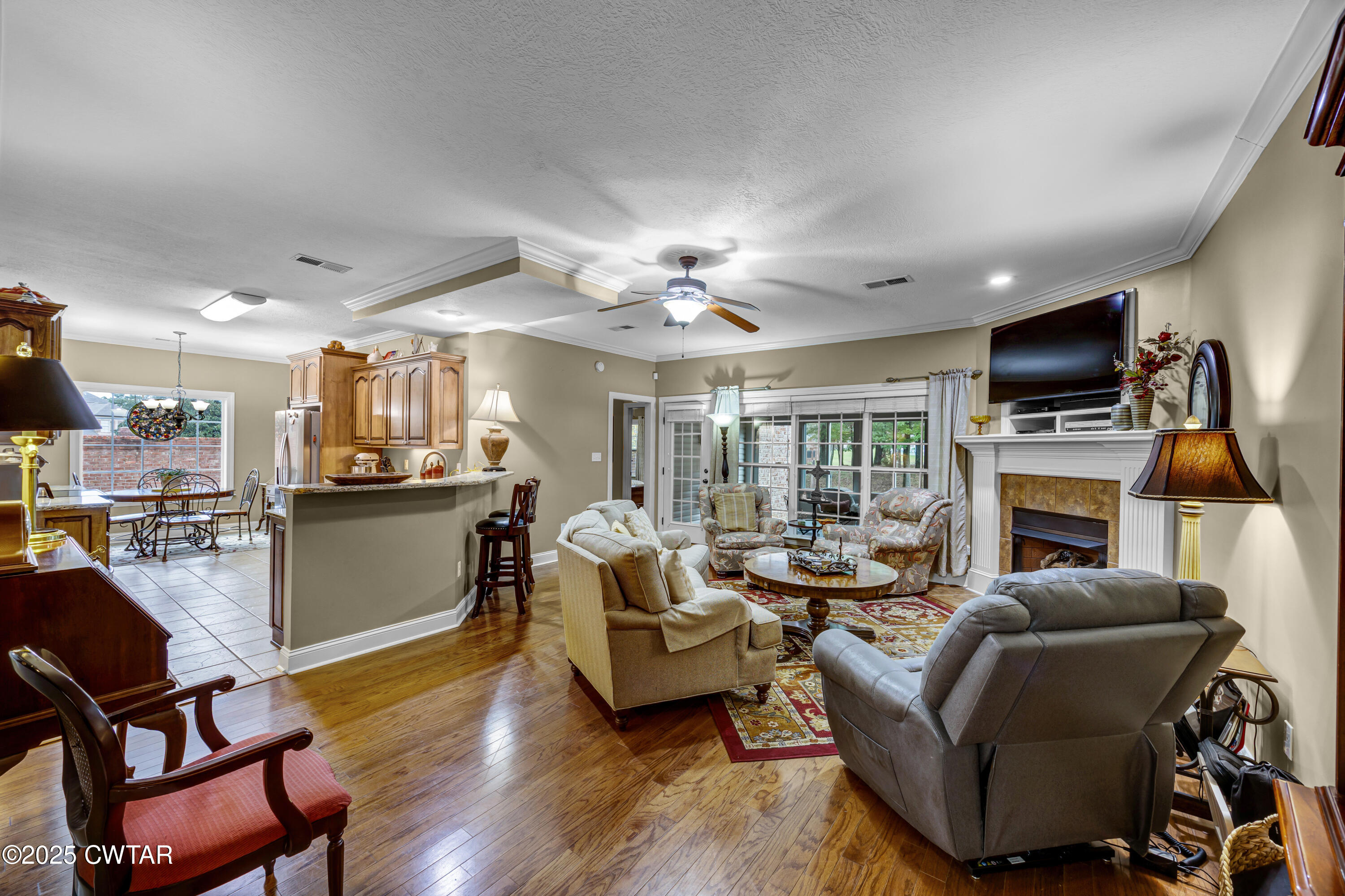 3 Emerald Ridge Cove Jackson, TN 38305 - Photo 6 of 26 a living room with furniture a fireplace and a flat screen tv