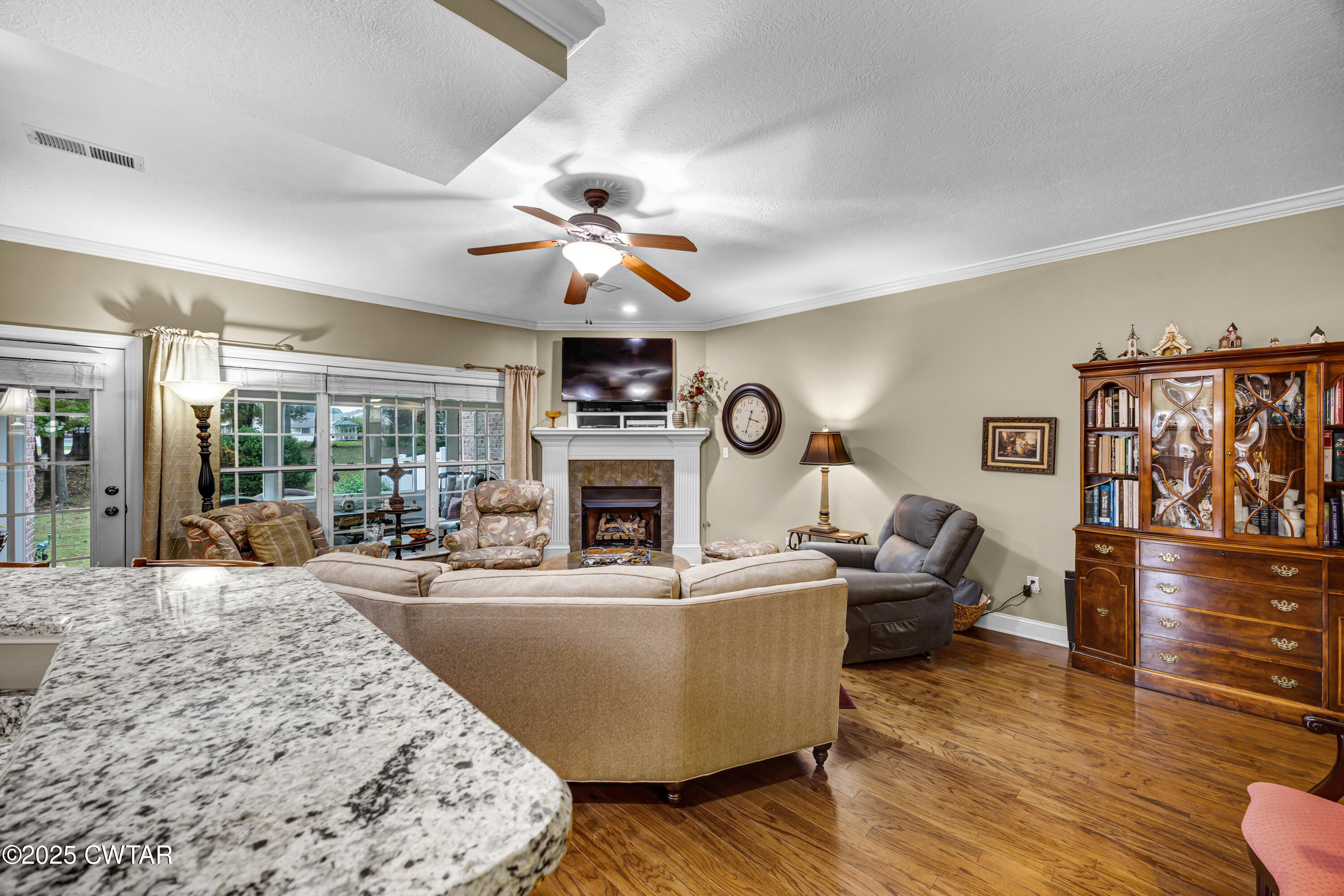 3 Emerald Ridge Cove Jackson, TN 38305 - Photo 7 of 26 a living room with furniture a fireplace and a flat screen tv