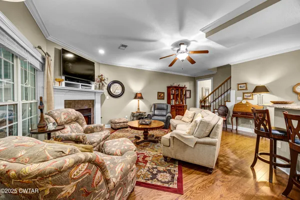 a living room with furniture and a chandelier