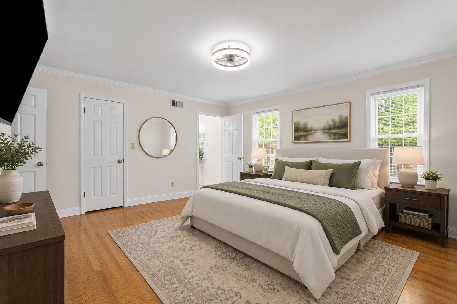 2218 Riverdale Road Germantown, TN 38138 - Photo 17 of 40 Generously sized primary bedroom featuring hardwood floors, abundant natural light, and plenty of space for a king-size furniture arrangement.