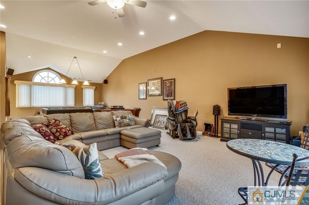 60 Higgins Road Old Bridge, NJ 08857 - Photo 16 of 25 a living room with furniture and a flat screen tv
