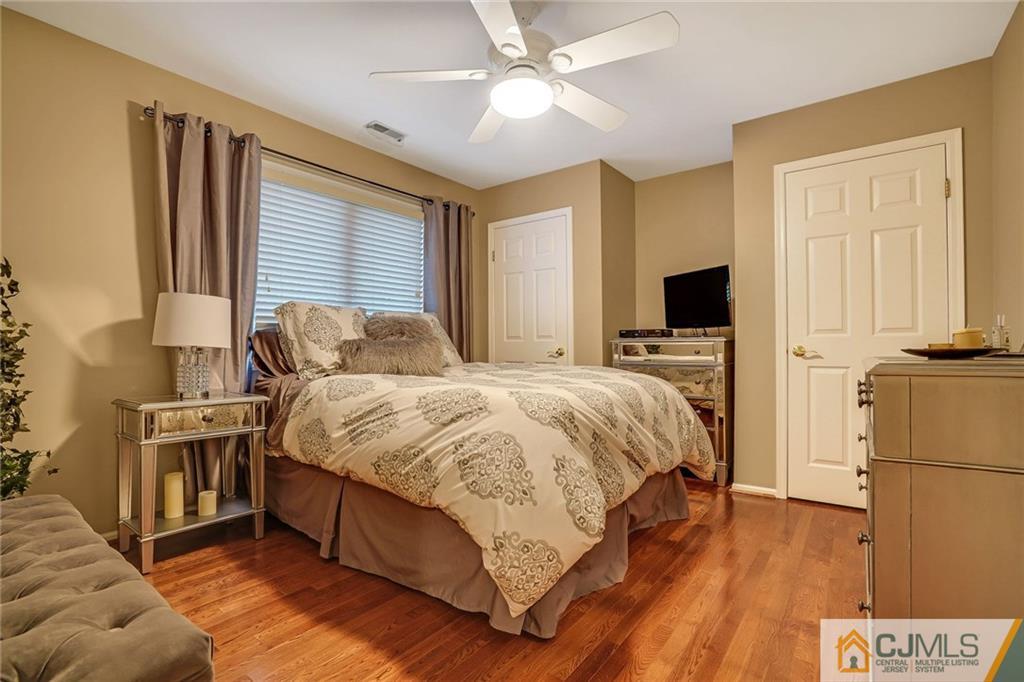 60 Higgins Road Old Bridge, NJ 08857 - Photo 18 of 25 a spacious bedroom with a bed and a flat screen tv
