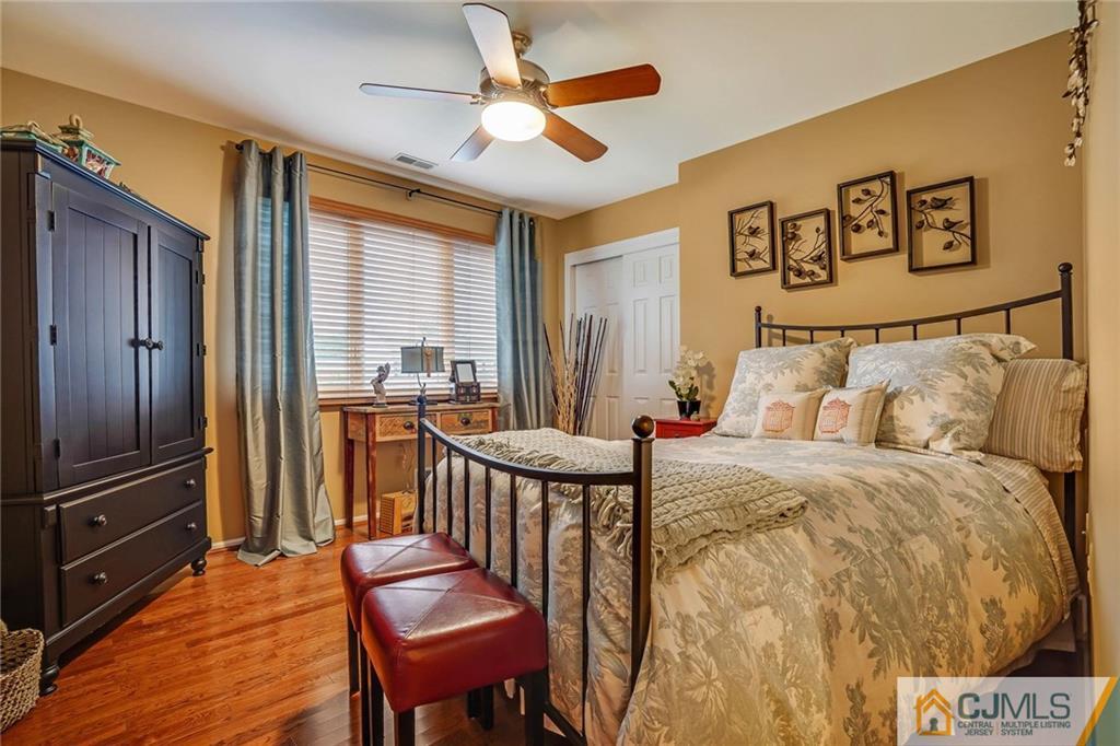 60 Higgins Road Old Bridge, NJ 08857 - Photo 20 of 25 a bedroom with a bed and a chandelier