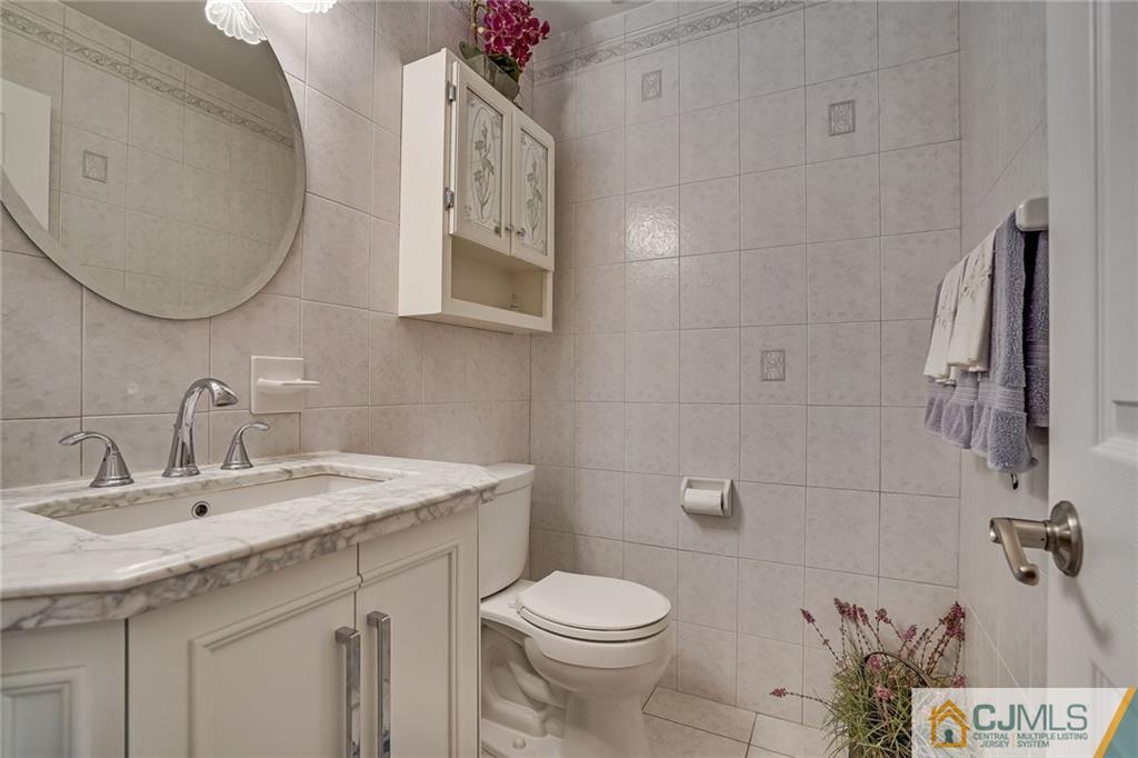 60 Higgins Road Old Bridge, NJ 08857 - Photo 6 of 25 a bathroom with a sink mirror vanity and toilet