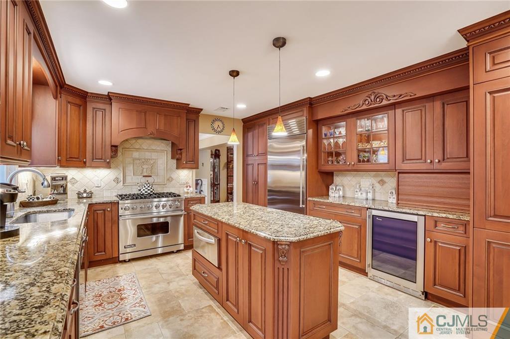 60 Higgins Road Old Bridge, NJ 08857 - Photo 9 of 25 a kitchen with stainless steel appliances granite countertop a stove top oven a sink and a refrigerator
