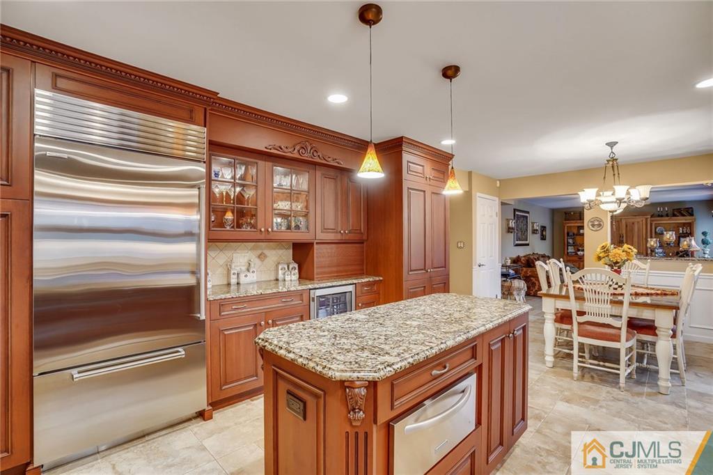 60 Higgins Road Old Bridge, NJ 08857 - Photo 10 of 25 a kitchen with kitchen island a sink table and chairs